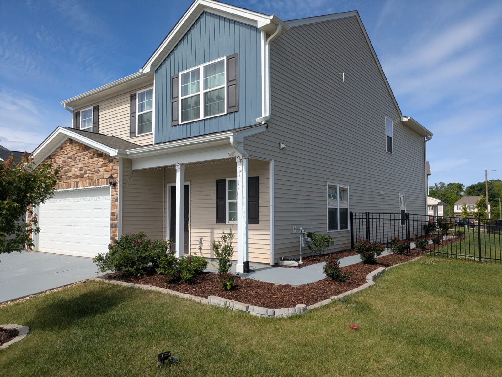 Detailed residential landscape design with mulch beds and shrubs