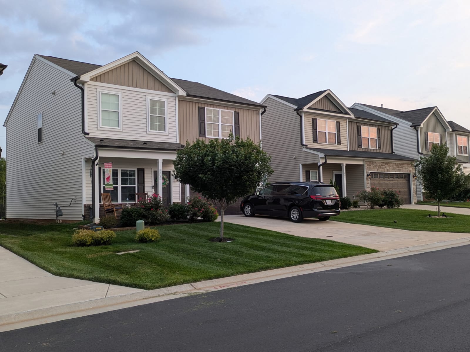 Front yard with newly mowed lawn and trimmed shrubs
